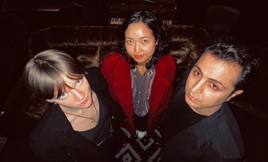 Fisheye lens photo of three people taken from above.
